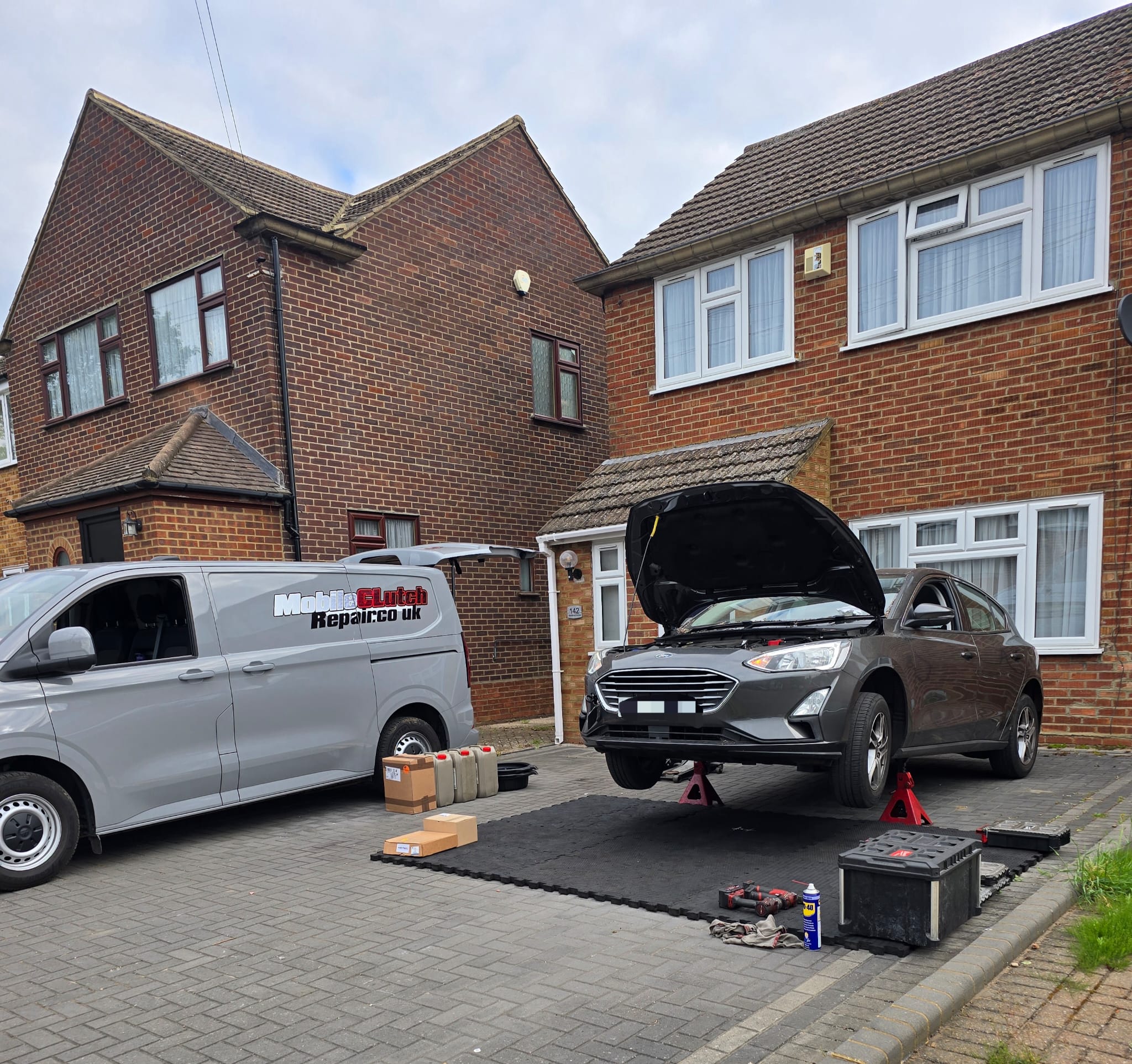 Mobile Clutch Repair van on a residential driveway next to a car being serviced